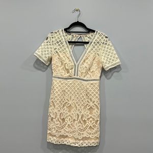 Lace nude cream peach white dress with a deep v cut and an open back lulus